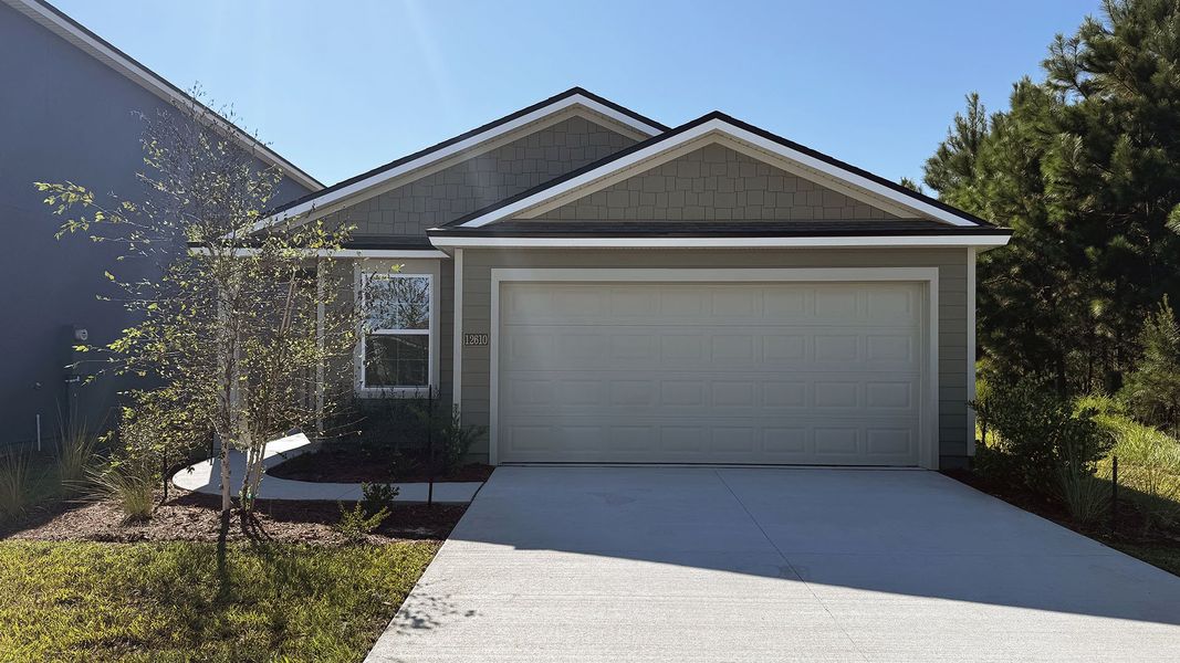 Front exterior of a new home in The Arbors, Jacksonville, FL, highlighting curb appeal (Image 1).