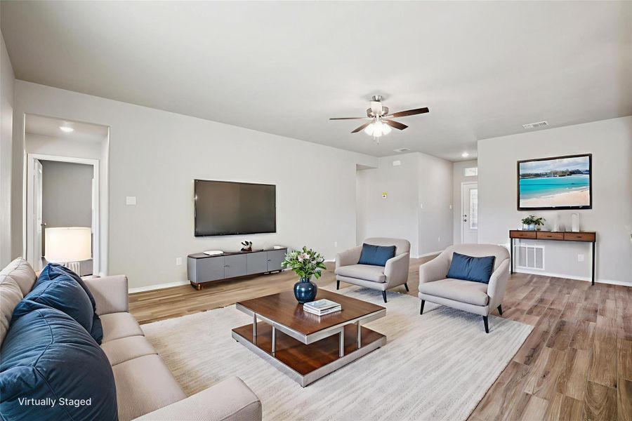 Living area featuring light wood-style flooring and a ceiling fan