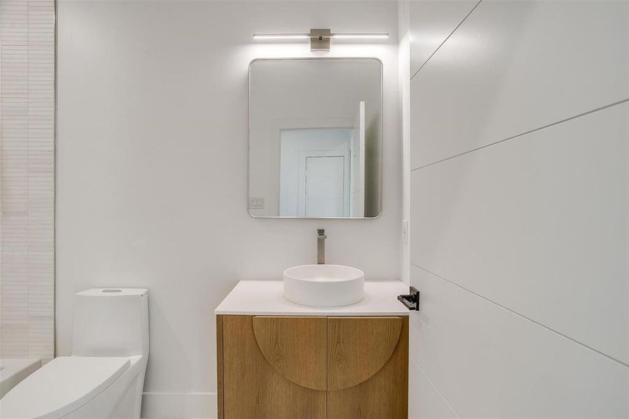 Bathroom with a shower, vanity, and toilet