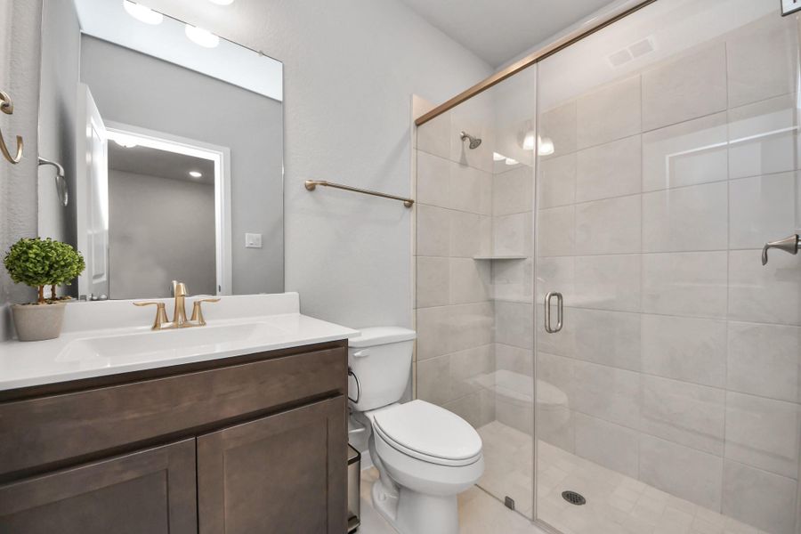 View of bathroom with walk-in title shower!