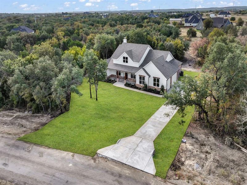 Front exterior of a new home in , Weatherford, TX, highlighting curb appeal (Image 26).