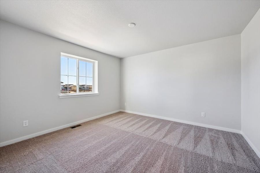 A room with a window and carpet. A room with a window and carpet.