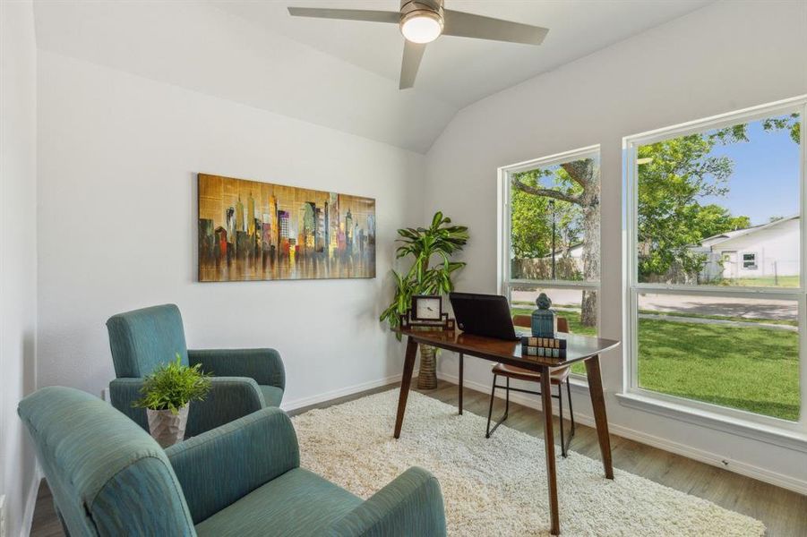 Home office with lofted ceiling, hardwood / wood-style floors, and ceiling fan