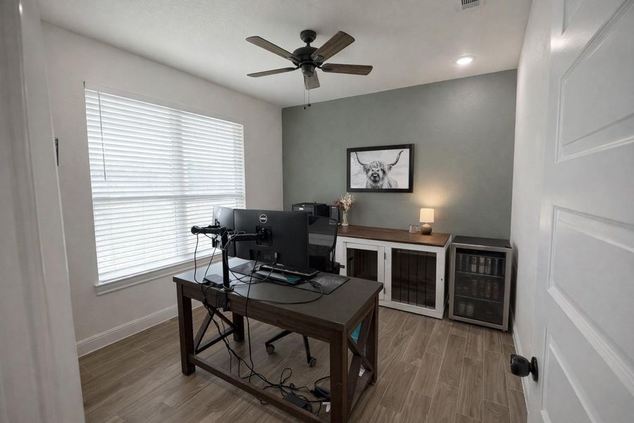 Home office with wood finished floors, ceiling fan, and recessed lighting Home office with wood finished floors, ceiling fan, and recessed lighting