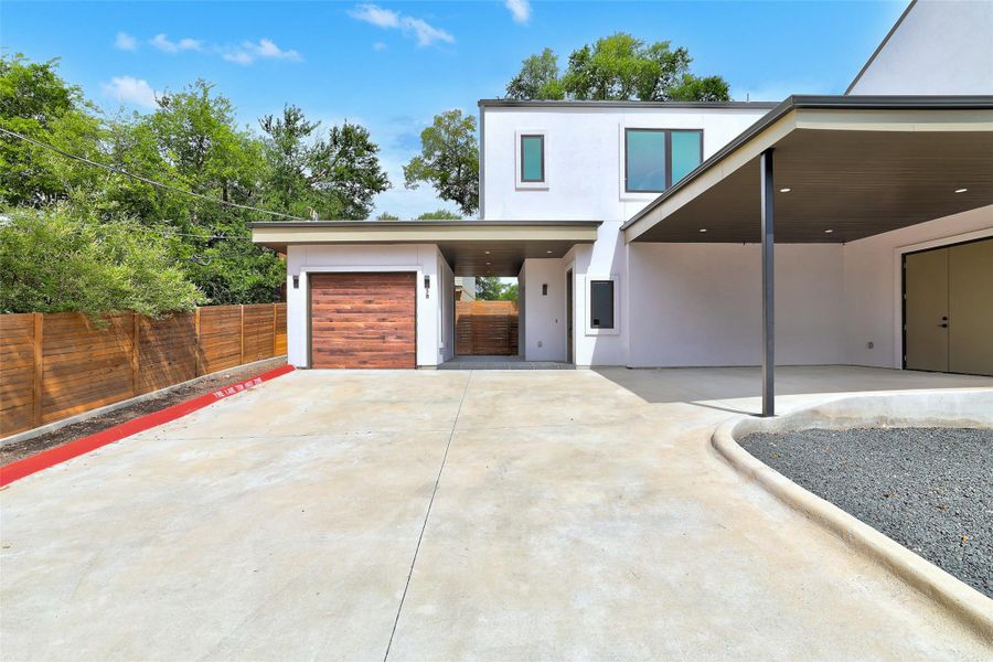 Contemporary house featuring concrete driveway and stucco siding Contemporary house featuring concrete driveway and stucco siding