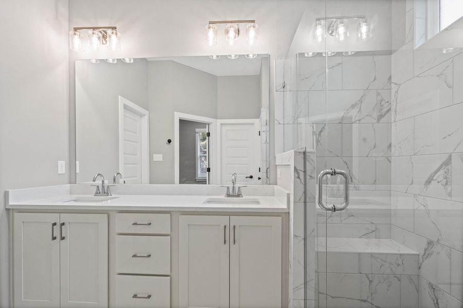 Double vanity with white cabinetry, integrated sinks, and brushed nickel faucets Double vanity with white cabinetry, integrated sinks, and brushed nickel faucets