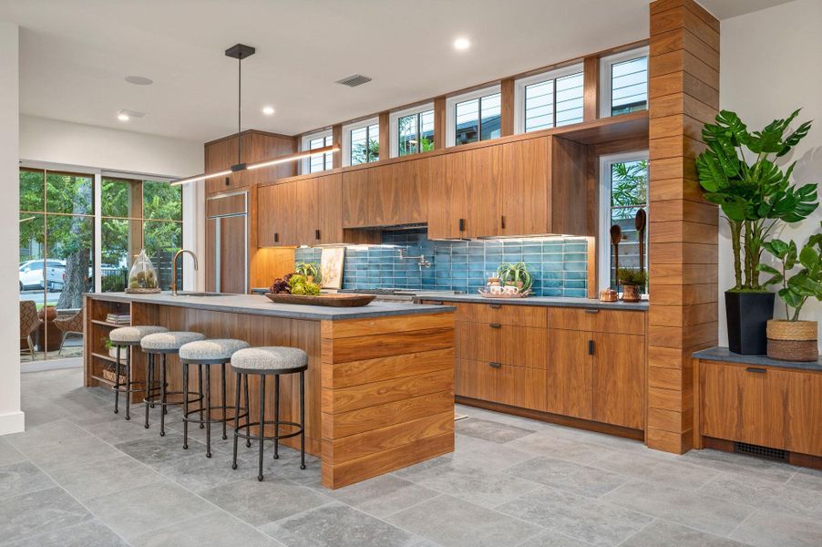 Kitchen with dark stone countertops & custom cabinetry Kitchen with dark stone countertops & custom cabinetry