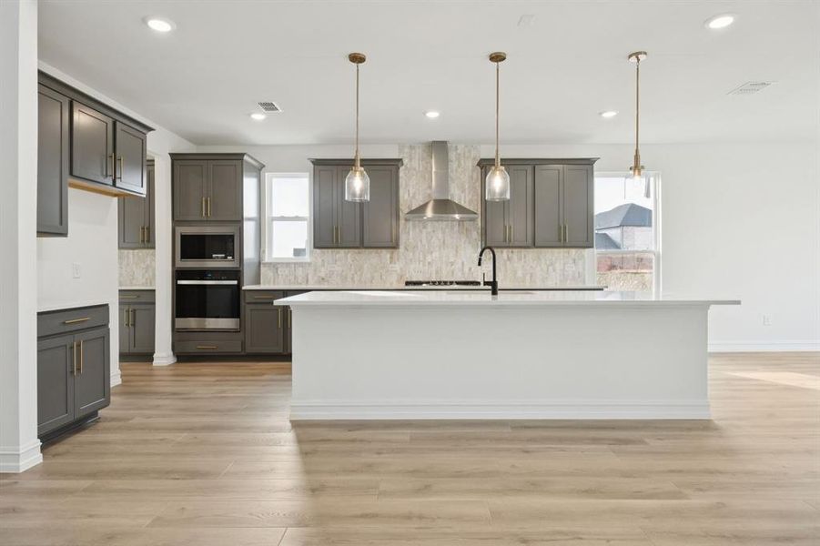 Spacious kitchen with eat-in bartop island. *Model representation.