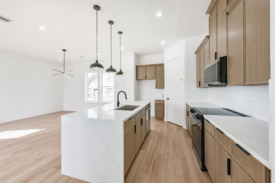 Plenty of counter and cabinet space, plus a coffee bar next to the refrigerator space.