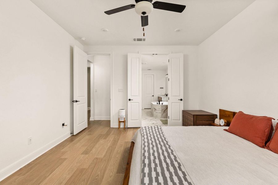 Spacious room featuring wood-finish flooring, recessed lighting, and a ceiling fan