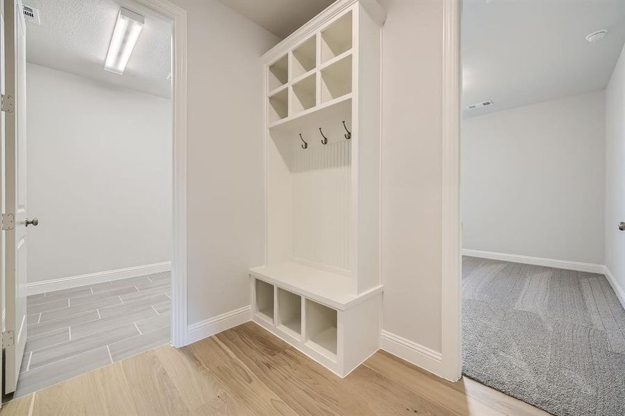 Mudroom with wood-type flooring