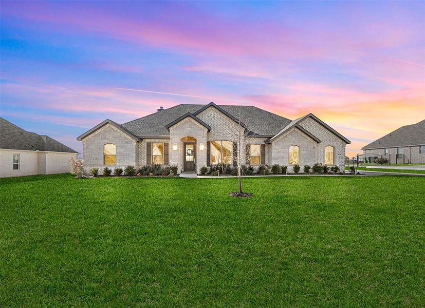 French provincial home featuring a yard