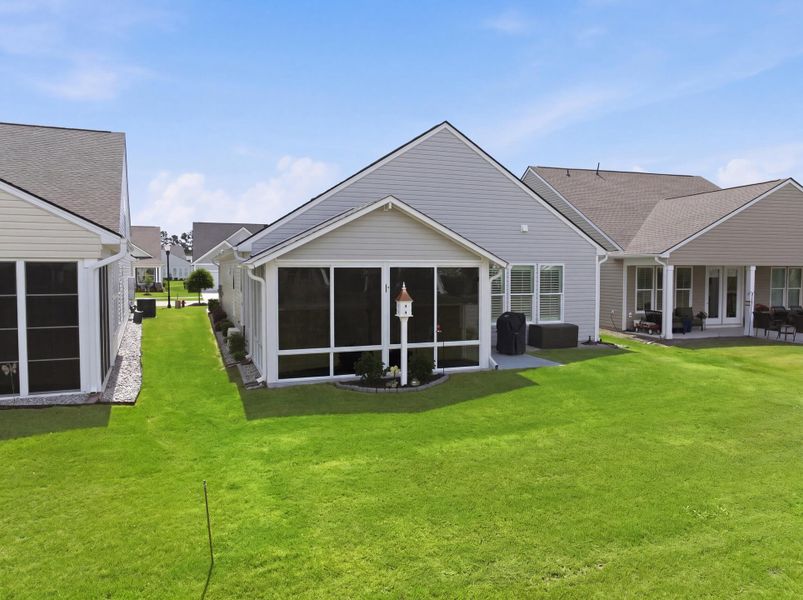 Exterior details and patio area of a home in K. Hovnanian's® Four Seasons at Lakes of Cane Bay, Summerville (Image 23).