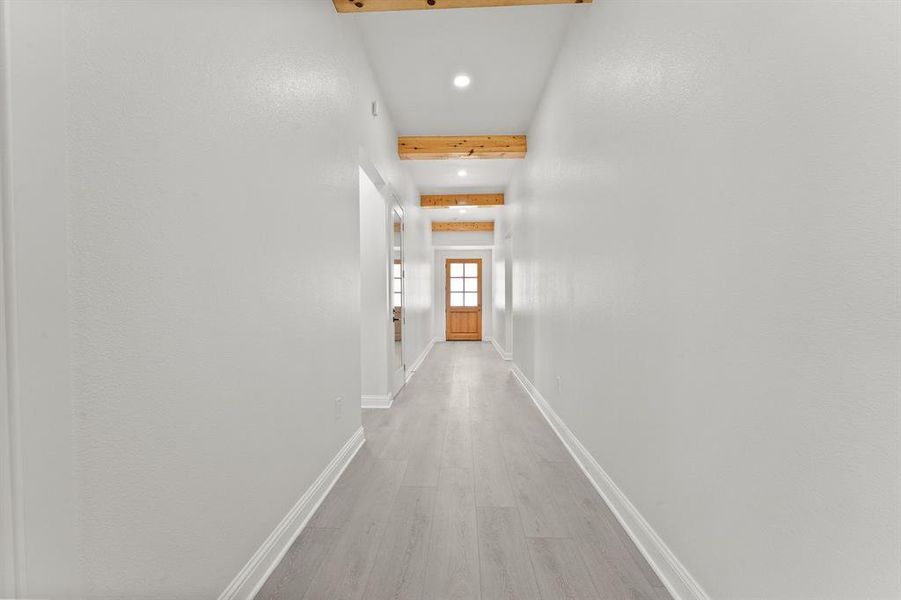 Hall featuring recessed lighting, light wood-style flooring, and beamed ceiling