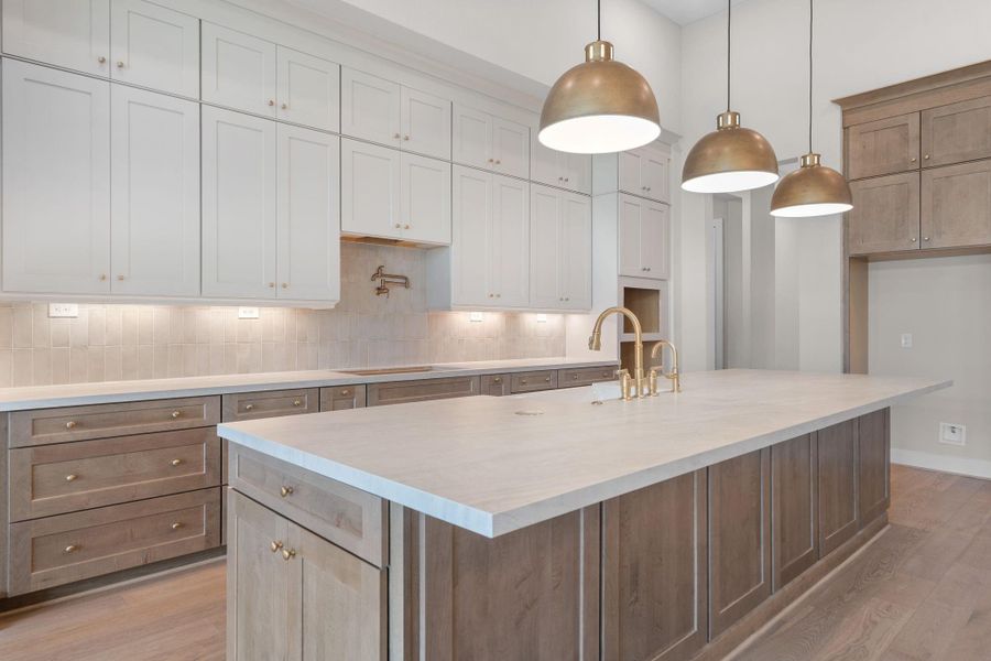 A massive island anchors the generous kitchen, ready for multiple cooks