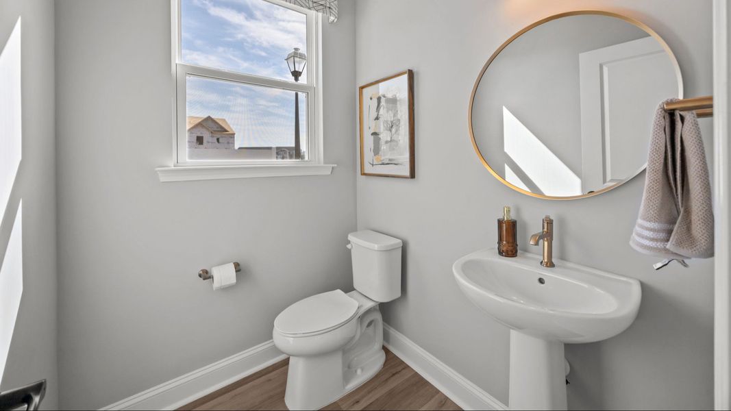 The Rochester Plan by DRB homes bathroom in solid white with gold fixtures in Charlotte, NC.