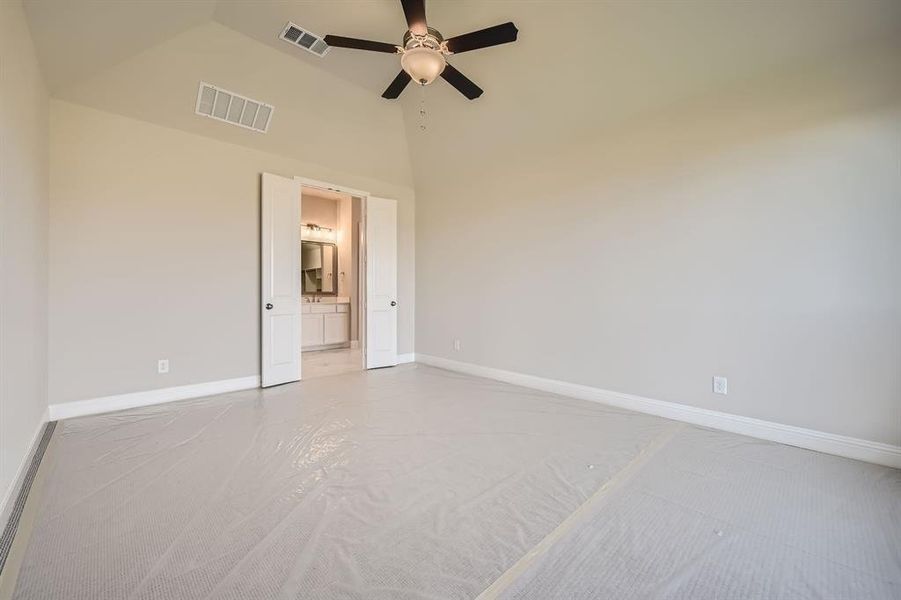 Spare room featuring high vaulted ceiling and ceiling fan