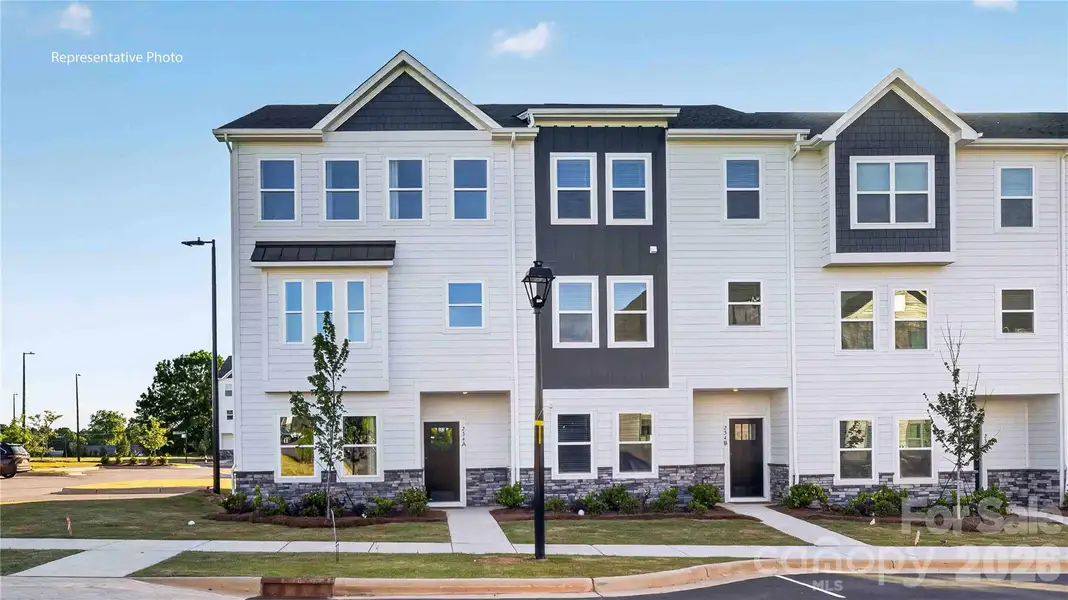 Front exterior of a new home in The Townes at Lake Norman, Mooresville, NC, highlighting curb appeal (Image 1). Front exterior of a new home in The Townes at Lake Norman, Mooresville, NC, highlighting curb appeal (Image 1).