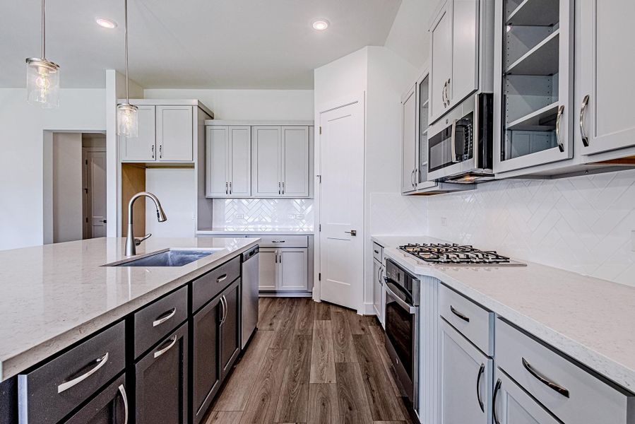 Stylish kitchen appointed with sleek cabinetry, ample workspace, and contemporary finishes Stylish kitchen appointed with sleek cabinetry, ample workspace, and contemporary finishes