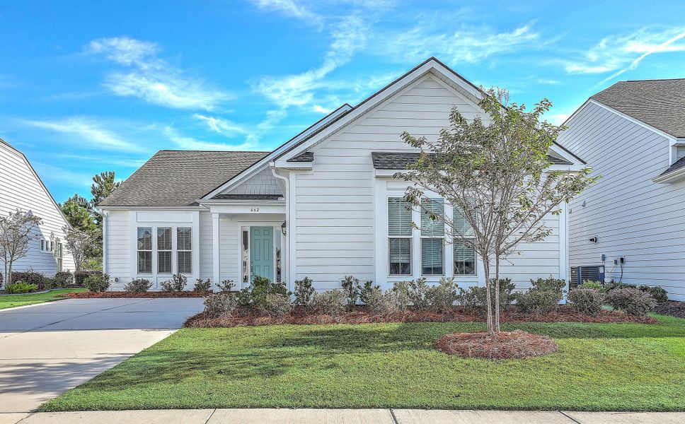 Front exterior of a new home in K. Hovnanian's® Four Seasons at Lakes of Cane Bay, Summerville, SC, highlighting curb appeal (Image 1).