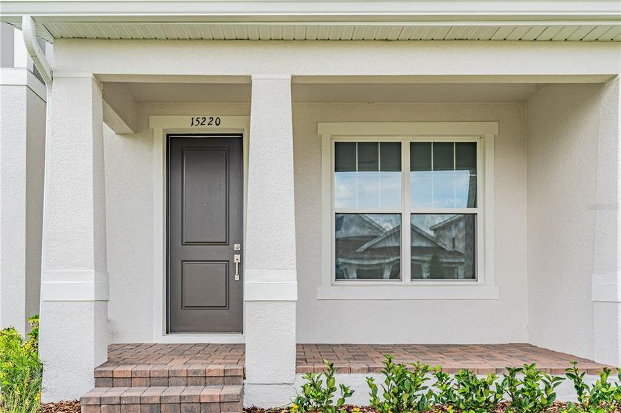 Exterior details and patio area of a home in Osprey Ranch Townhomes, Winter Garden (Image 22).