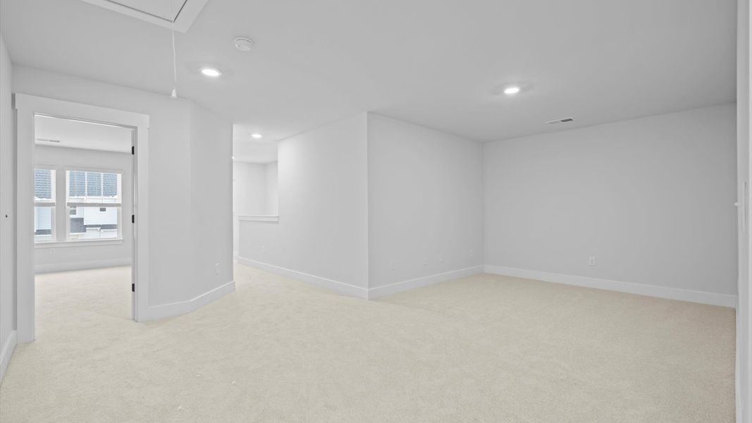 Highly functional loft featuring cozy carpet and open views of the home’s living areas