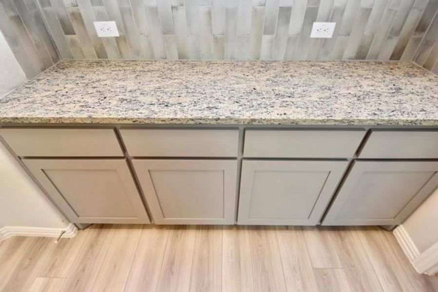 Granite countertops and tile backsplash