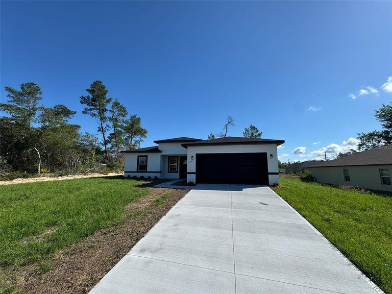 Front exterior of a new home in , Ocala, FL, highlighting curb appeal (Image 1).