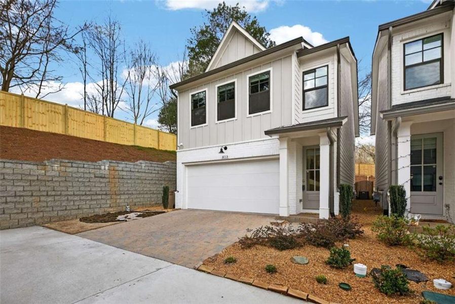 Front exterior of a new home in The Village at Towne Lake, Woodstock, GA, highlighting curb appeal (Image 23).
