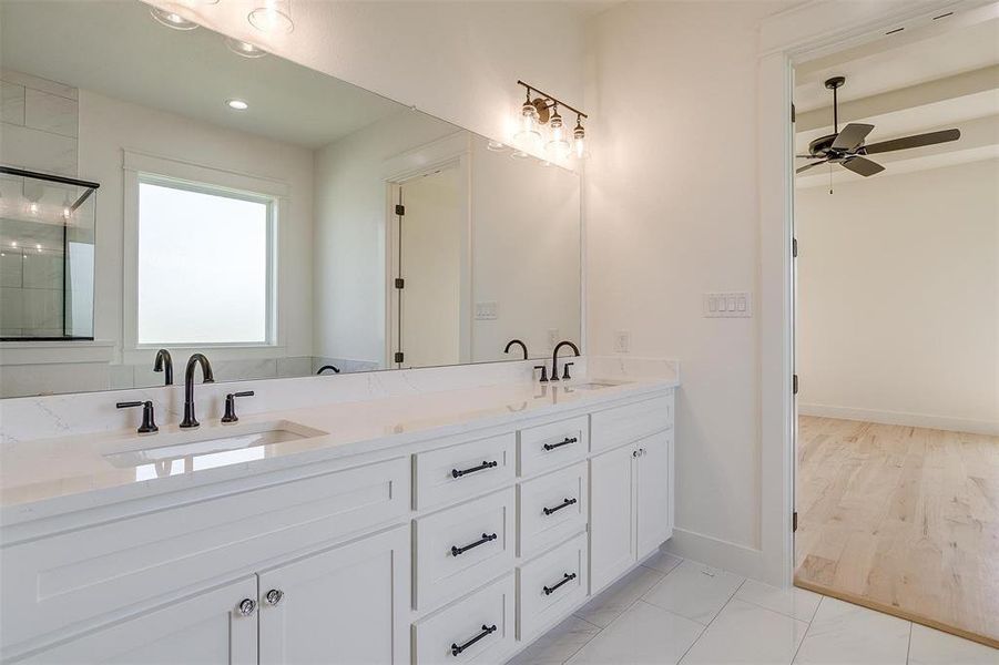 Full bathroom featuring a ceiling fan, double vanity, baseboards, a shower, and recessed lighting