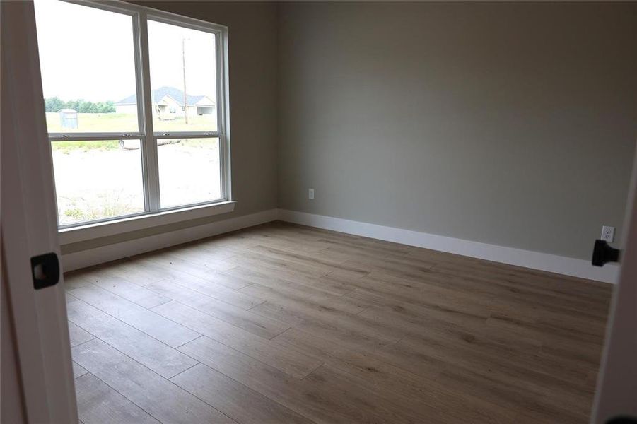 Unfurnished room featuring hardwood / wood-style flooring