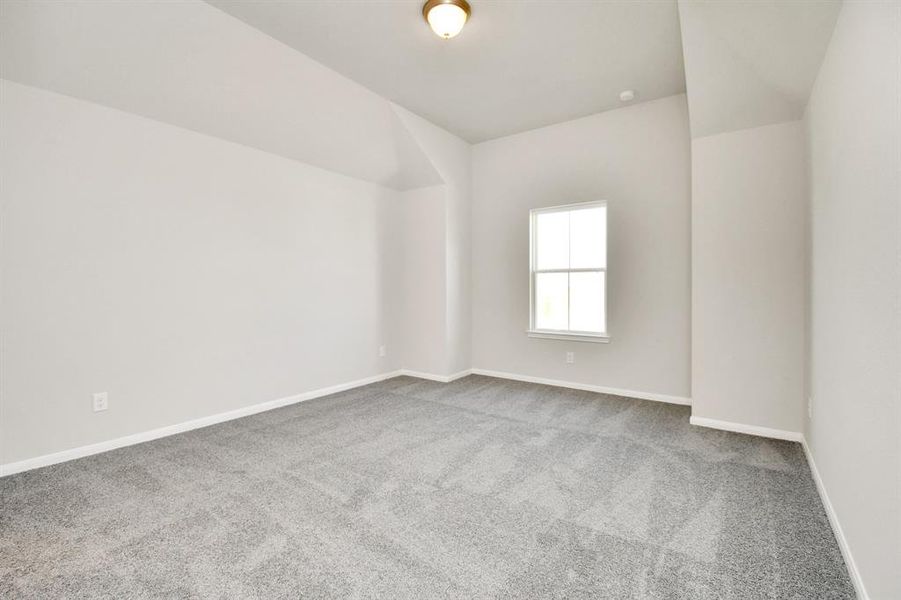 Fourth bedroom features plush carpet and large window.