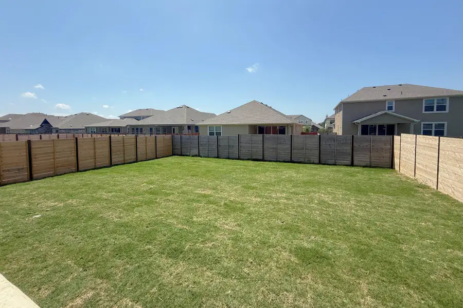 Expansive grassy yard area featuring full perimeter fencing Expansive grassy yard area featuring full perimeter fencing