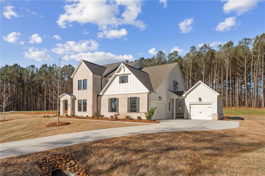 Front exterior of a new home in The Reserve at Knollwood, Canton, GA, highlighting curb appeal (Image 21).