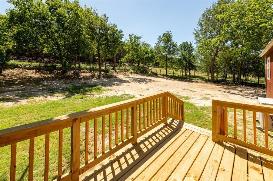 Expansive outdoor deck with natural wood railing and decking