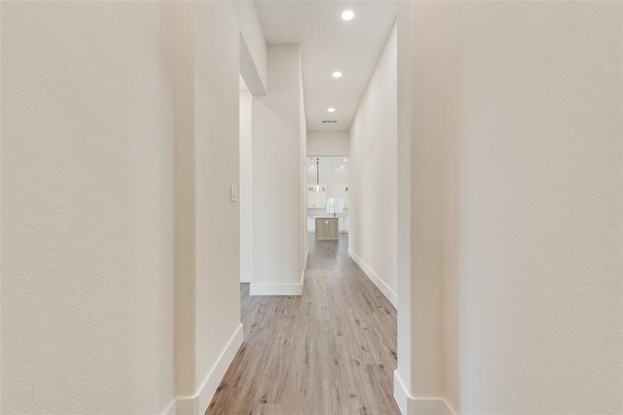 Hallway featuring light wood-style floors and recessed lighting