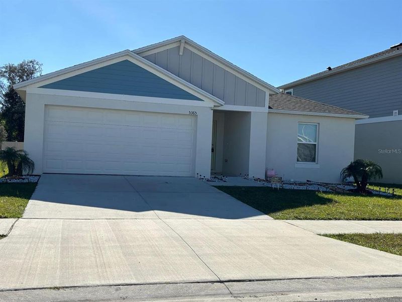 Front exterior of a new home in Hammock Reserve, Haines City, FL, highlighting curb appeal (Image 1). Front exterior of a new home in Hammock Reserve, Haines City, FL, highlighting curb appeal (Image 1).