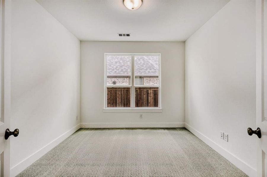 Carpeted spare room with baseboards