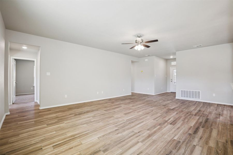 Spare room featuring a ceiling fan and light wood-style flooring