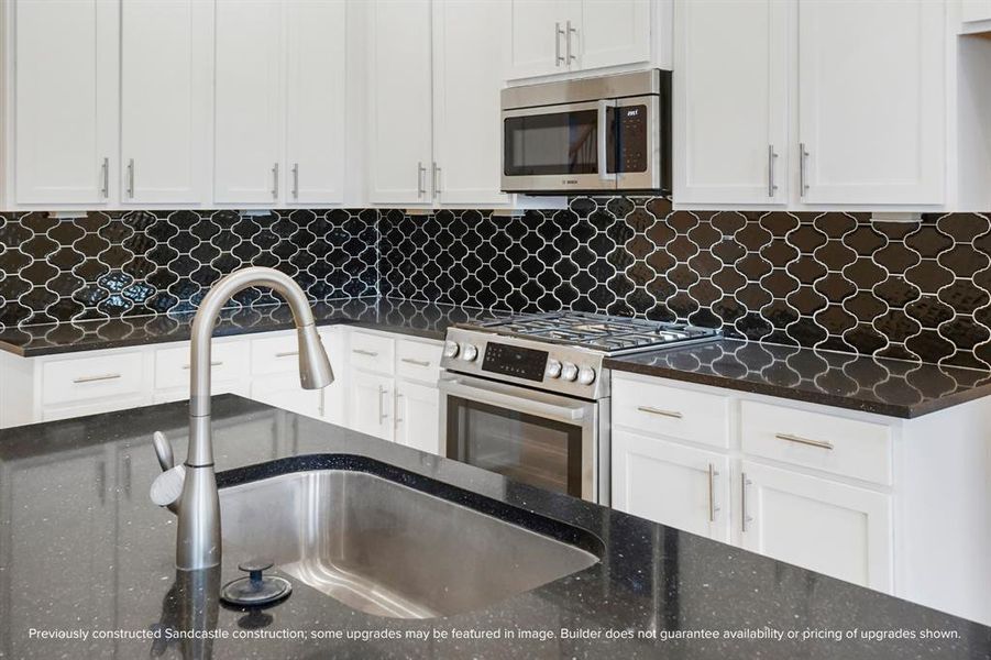 Enjoy the standard stainless steel appliances including a five-burner gas range, microwave with vent, and an undermount sink with faucet with pull-down sprayer—a chef’s dream.