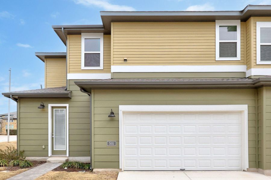 View of front of property with an attached garage and concrete driveway