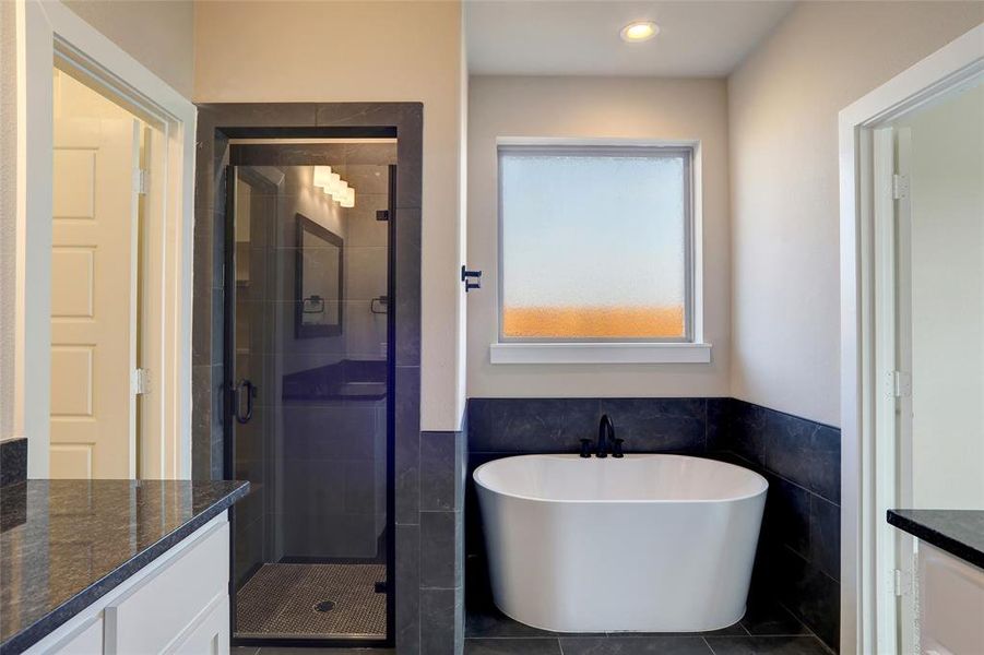 Bathroom with vanity, independent shower and bath, tile patterned flooring, and tile walls