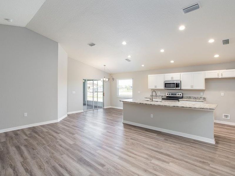 Enjoy a spacious, open living area with luxury vinyl plank flooring. Photo showcases a home with similar finishes. colors and design options in actual home for sale may differ.