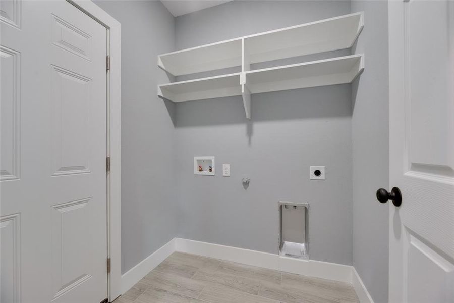 Laundry room with hookup for a washing machine, gas dryer hookup, electric dryer hookup, and light hardwood / wood-style flooring