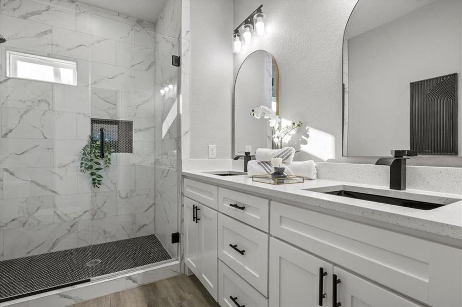 Bathroom with vanity, wood-type flooring, and tiled shower