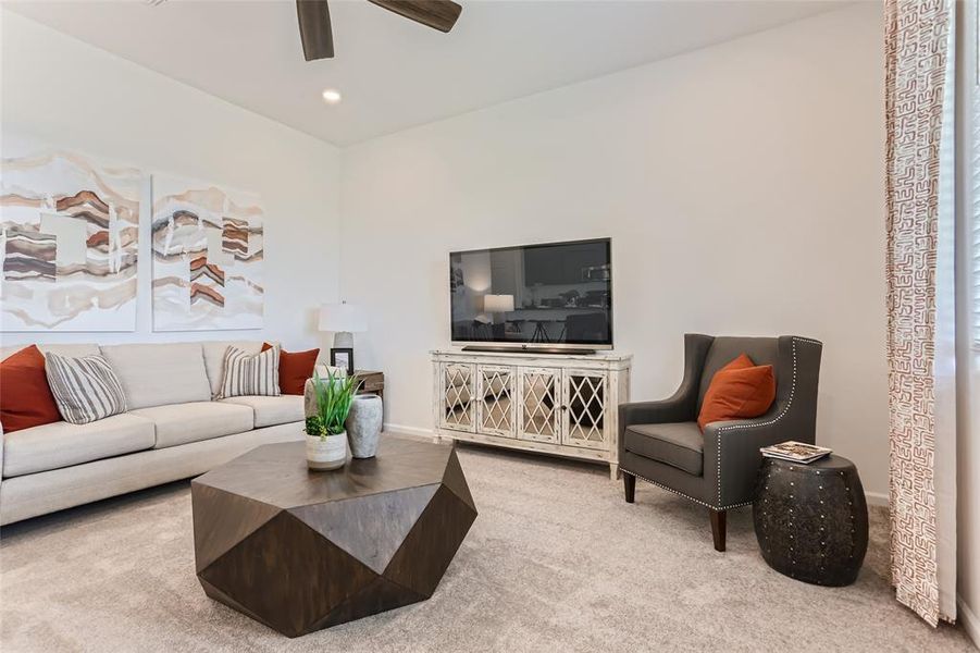 Living area with carpet floors, recessed lighting, and a ceiling fan