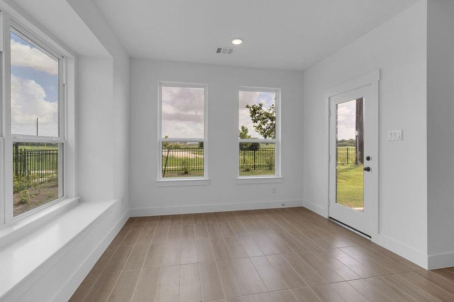 Large windows frame the space, allowing natural light to flood in, casting a cheerful ambiance that makes every meal feel special.