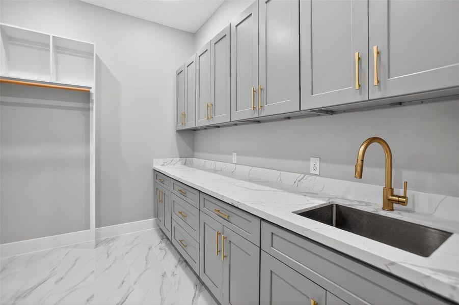 The large laundry room with convenient direct access to the owner’s walk-in closet makes laundry days a breeze