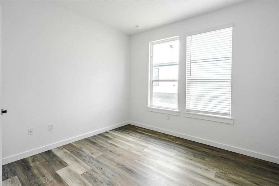 Bright windows illuminate this versatile room with durable laminate flooring. Bright windows illuminate this versatile room with durable laminate flooring.