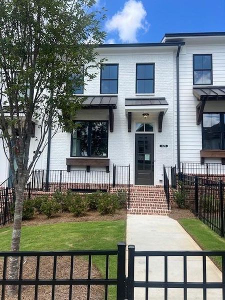 Front exterior of a new home in Palisades Townhomes, Cumming, GA, highlighting curb appeal (Image 16).